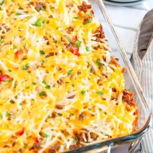 sausage hashbrown breakfast casserole served in a glass casserole dish