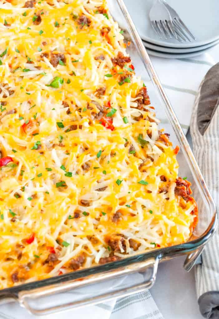 sausage hashbrown breakfast casserole served in a glass casserole dish