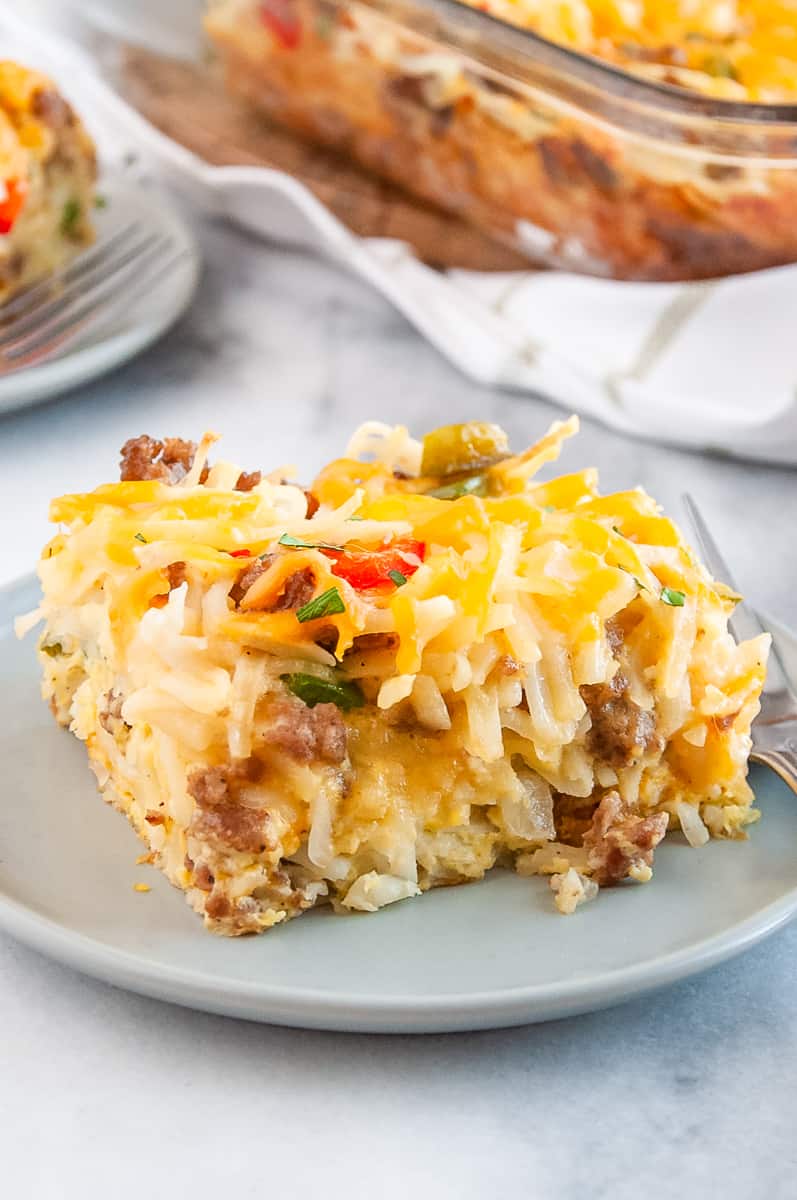 serving of sausage hashbrown breakfast casserole served on a grey round plate