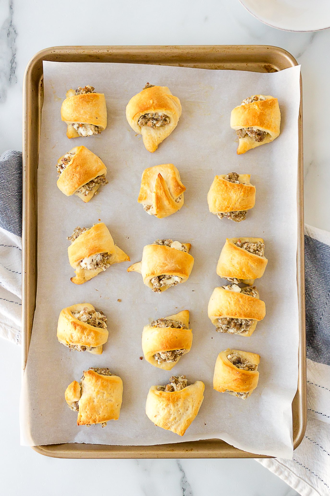 sausage cream cheese crescent rolls on a baking sheet