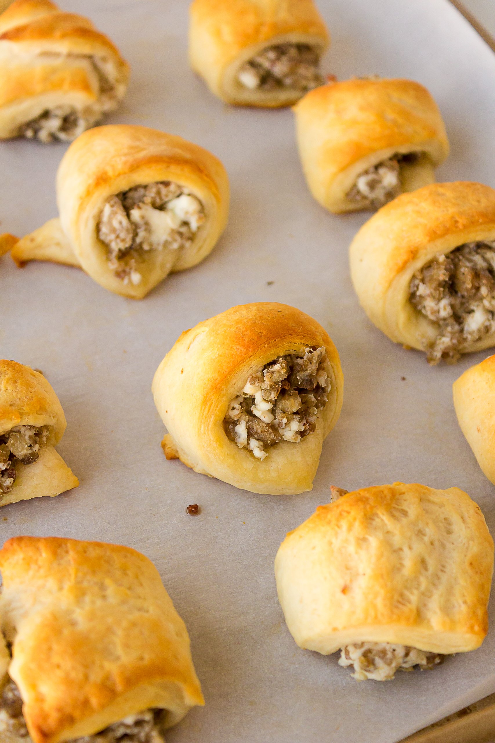 sausage cream cheese crescent rolls on a baking sheet