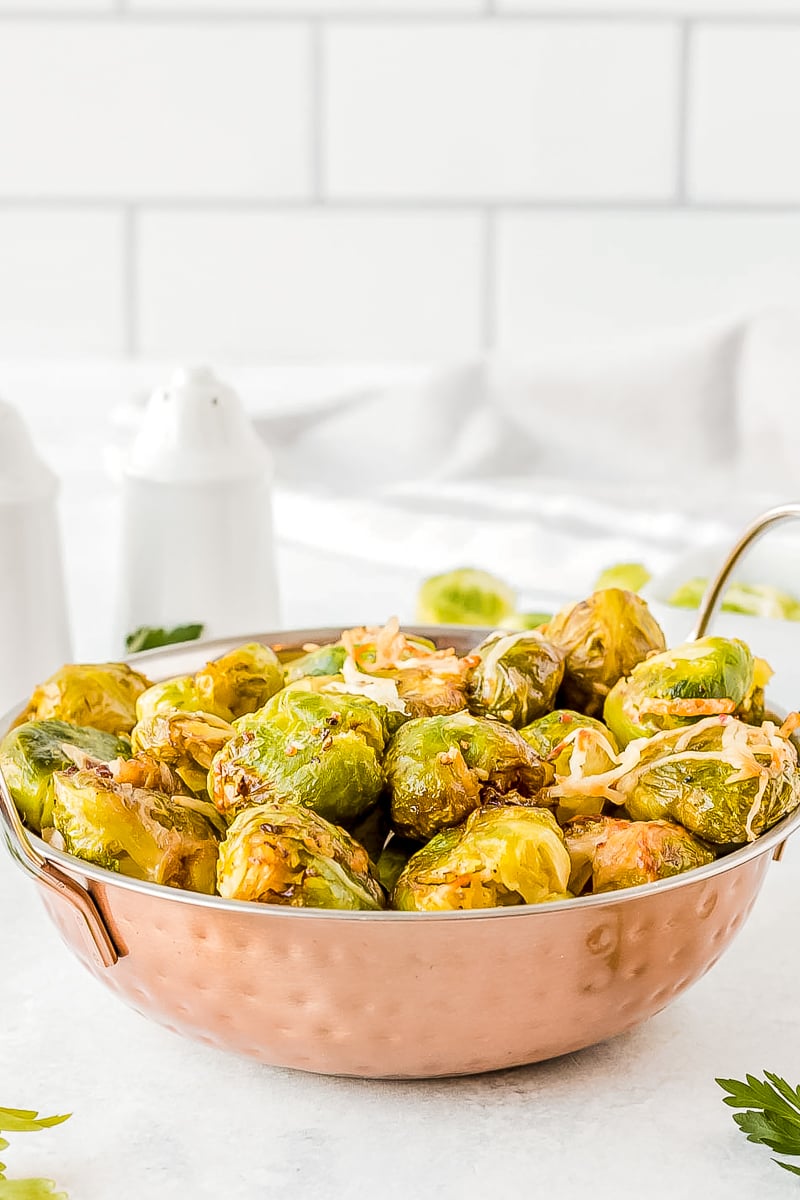 air fryer brussel sprouts served in a copper metal bowl with handles