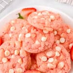 strawberry cake mix cookies served on a white plate garnished with fresh halved strawberries