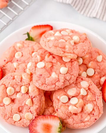 strawberry cake mix cookies served on a white plate garnished with fresh halved strawberries