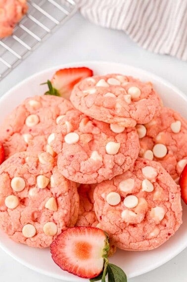 strawberry cake mix cookies served on a white plate garnished with fresh halved strawberries