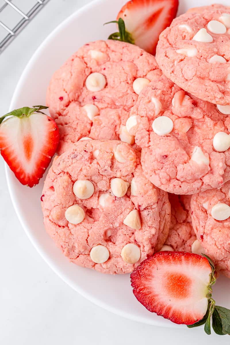 strawberry cake mix cookies serve on a white plate garnished with fresh halved strawberries