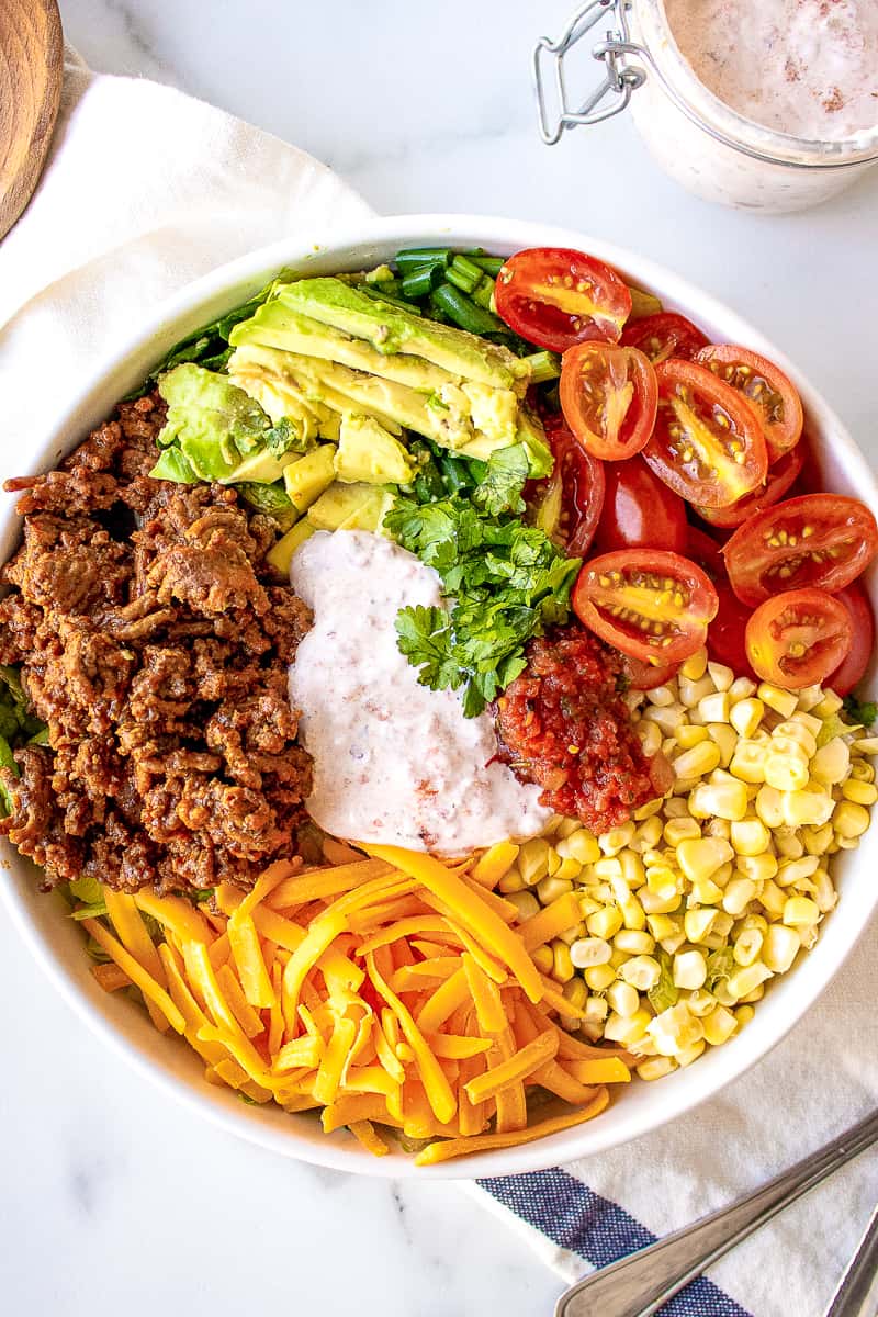 taco salad ingredients in a white bowl