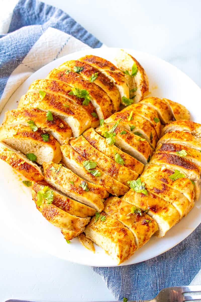 oven baked chicken breasts on a platter cut