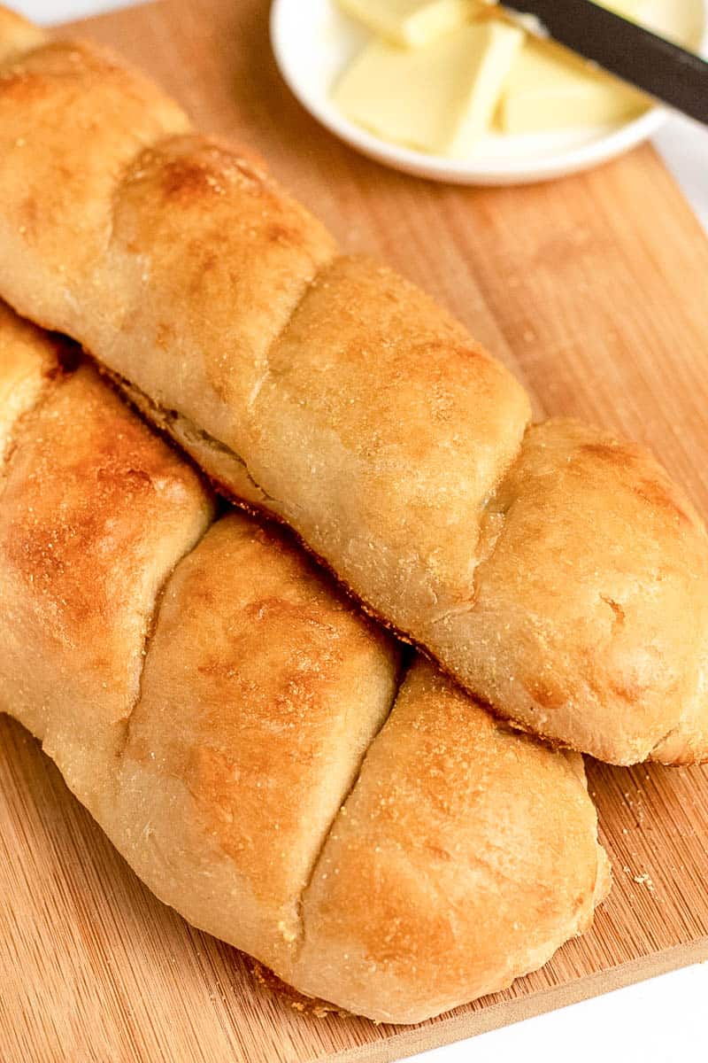 baked french bread on a wooden cutting board