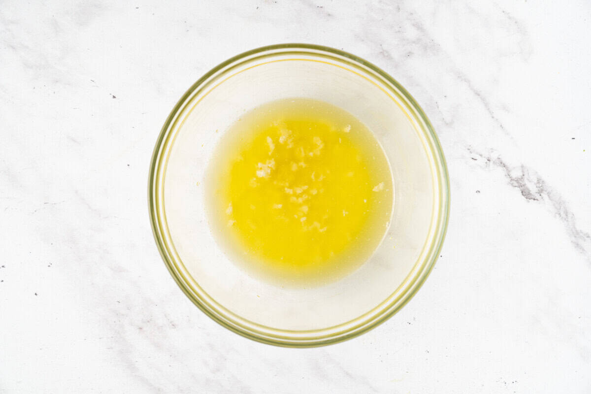 Garlic butter in glass bowl.