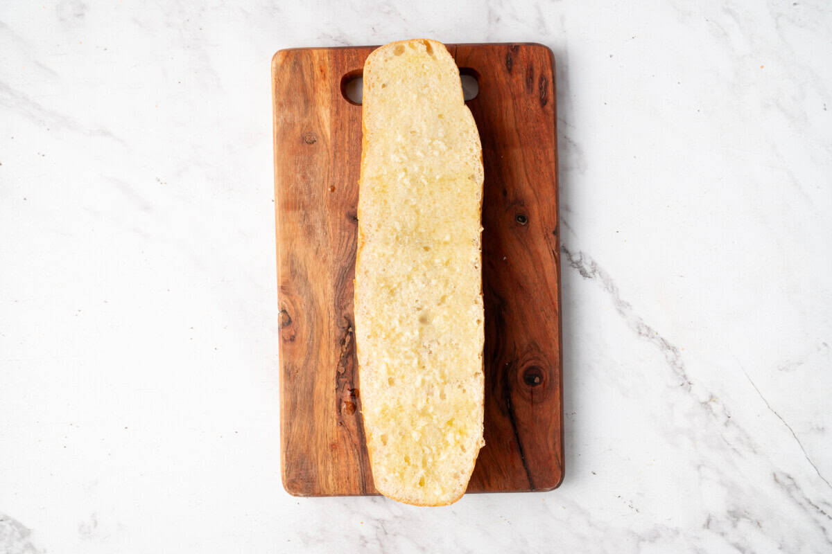 French bread half spread with butter.