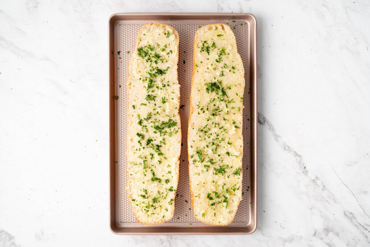 Garlic bread on baking sheet before baking.