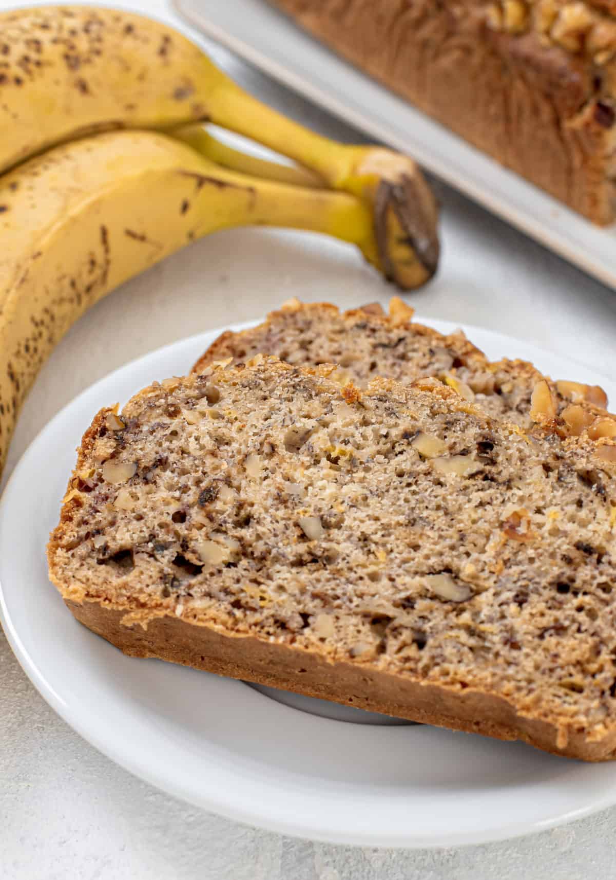 two slices of homemade banana walnut bread on a plate