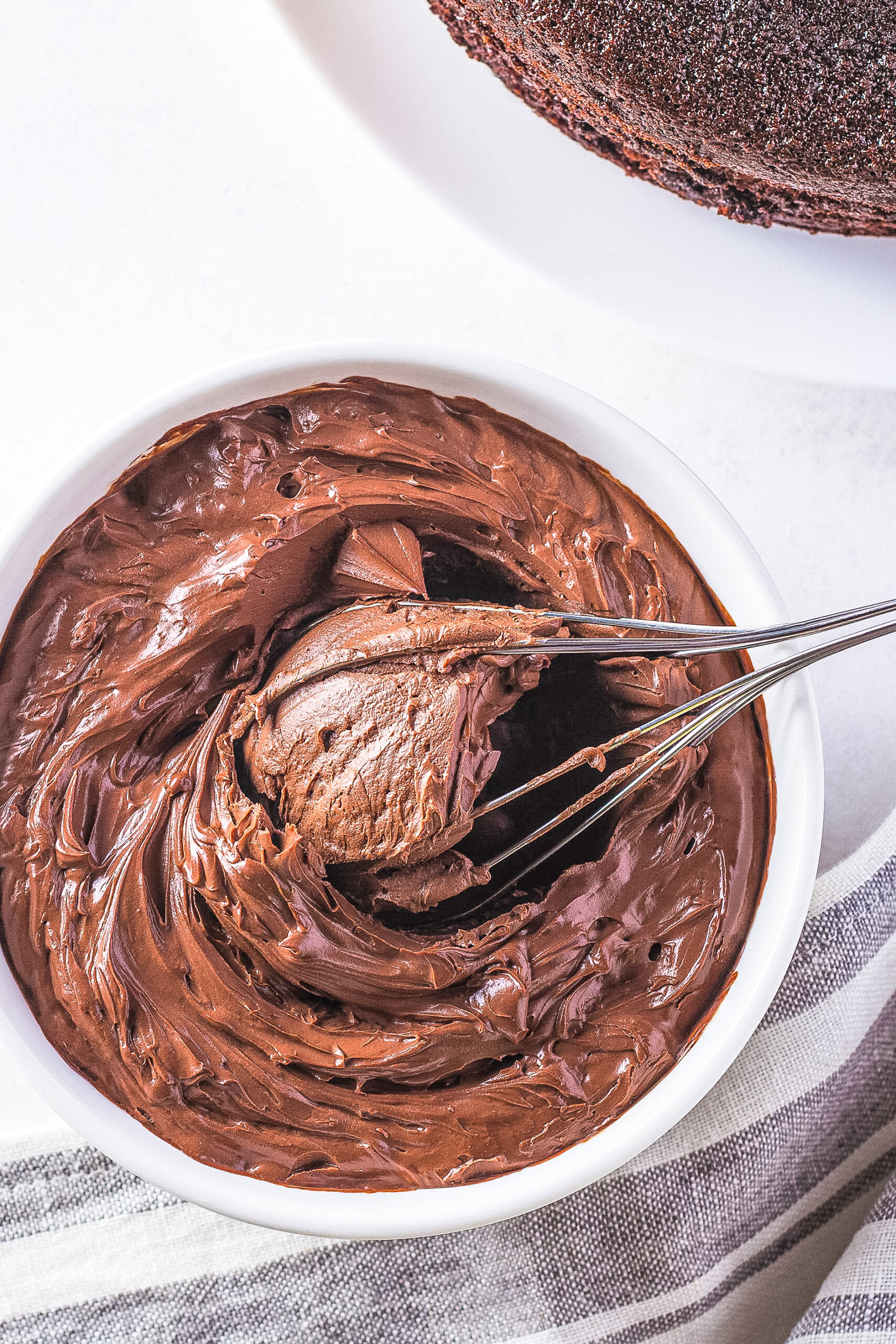 chocolate frosting whisked in a white bowl