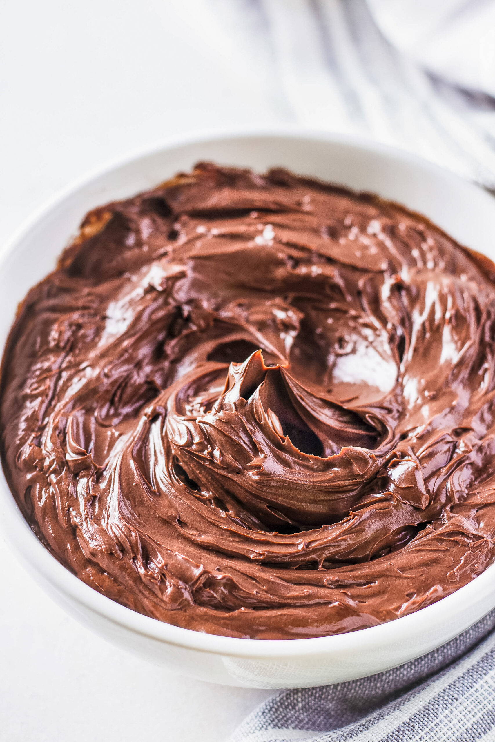 chocolate frosting in a white bowl