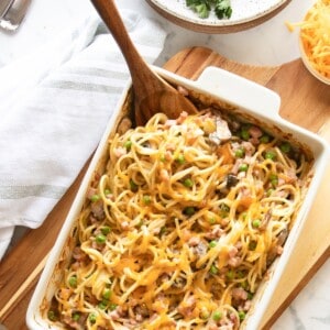 Overhead view of ham tetrazzini in baking dish with wooden spoon