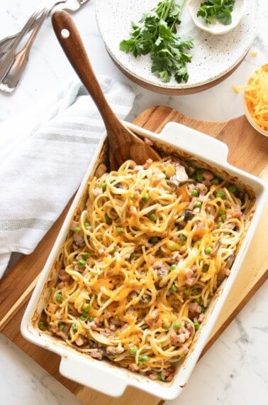Overhead view of ham tetrazzini in baking dish with wooden spoon