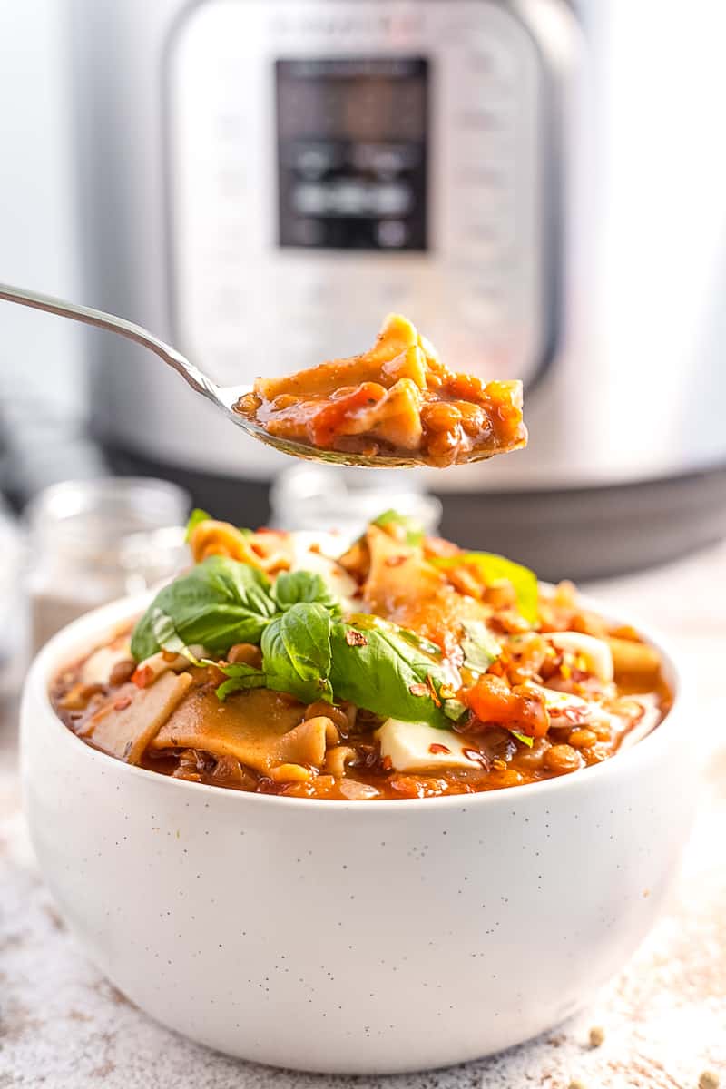spoonful of instant pot lasagna soup hovered on top of the bowl of soup