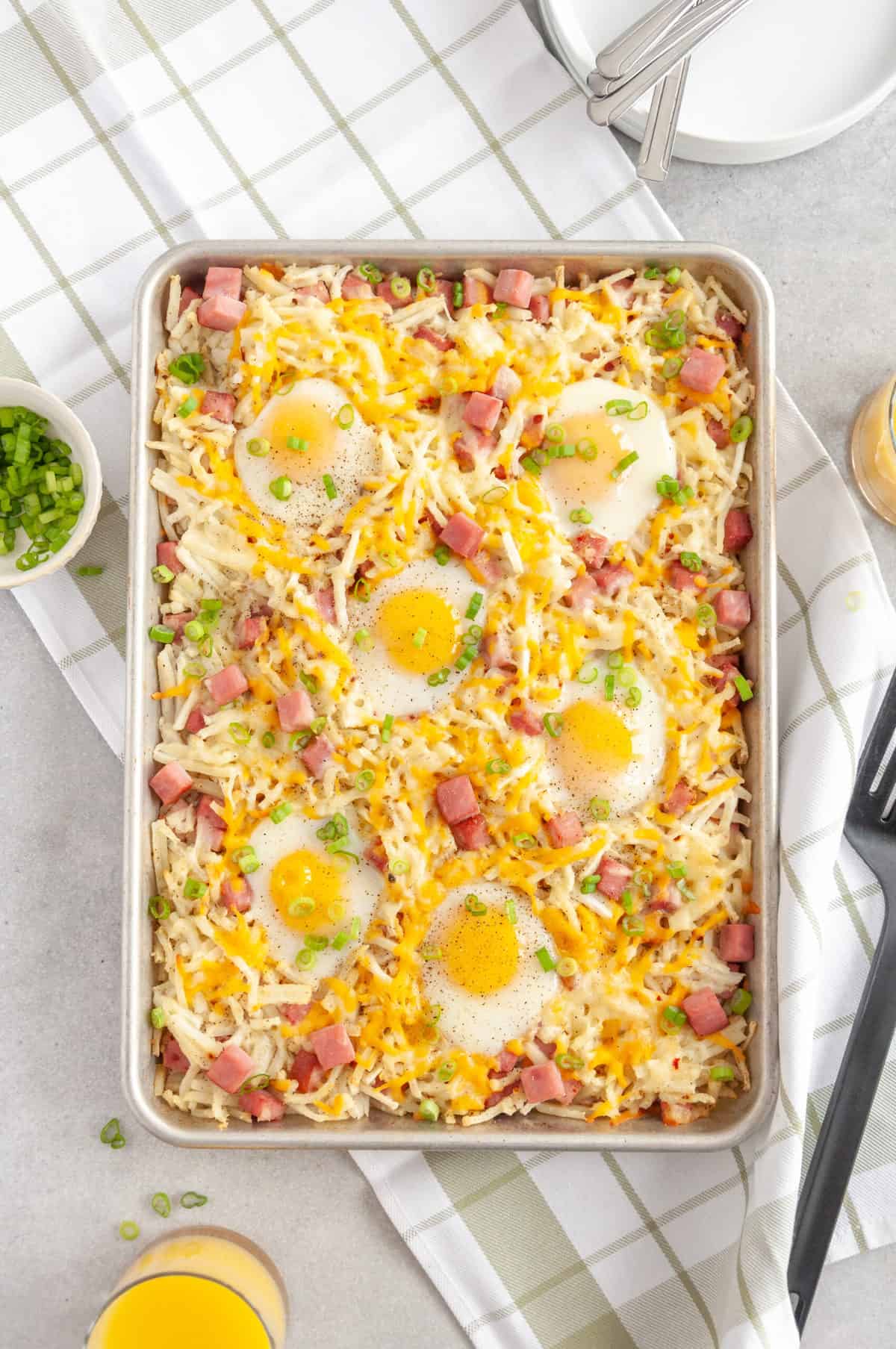 sheet pan breakfast bake sitting on a grey countertop on top of a kitchen towel