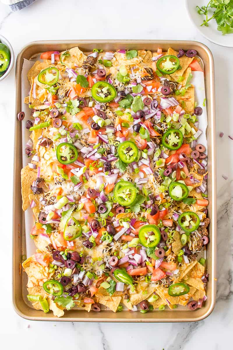 sheet pan nachos recipe on a baking sheet tray