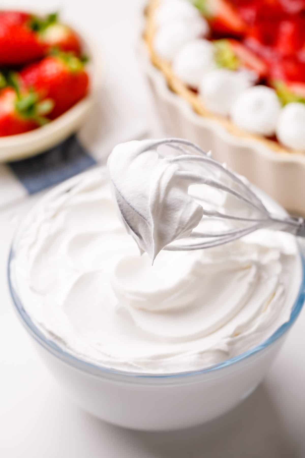 whipped chantilly cream from scratch with a whisk in a glass bowl
