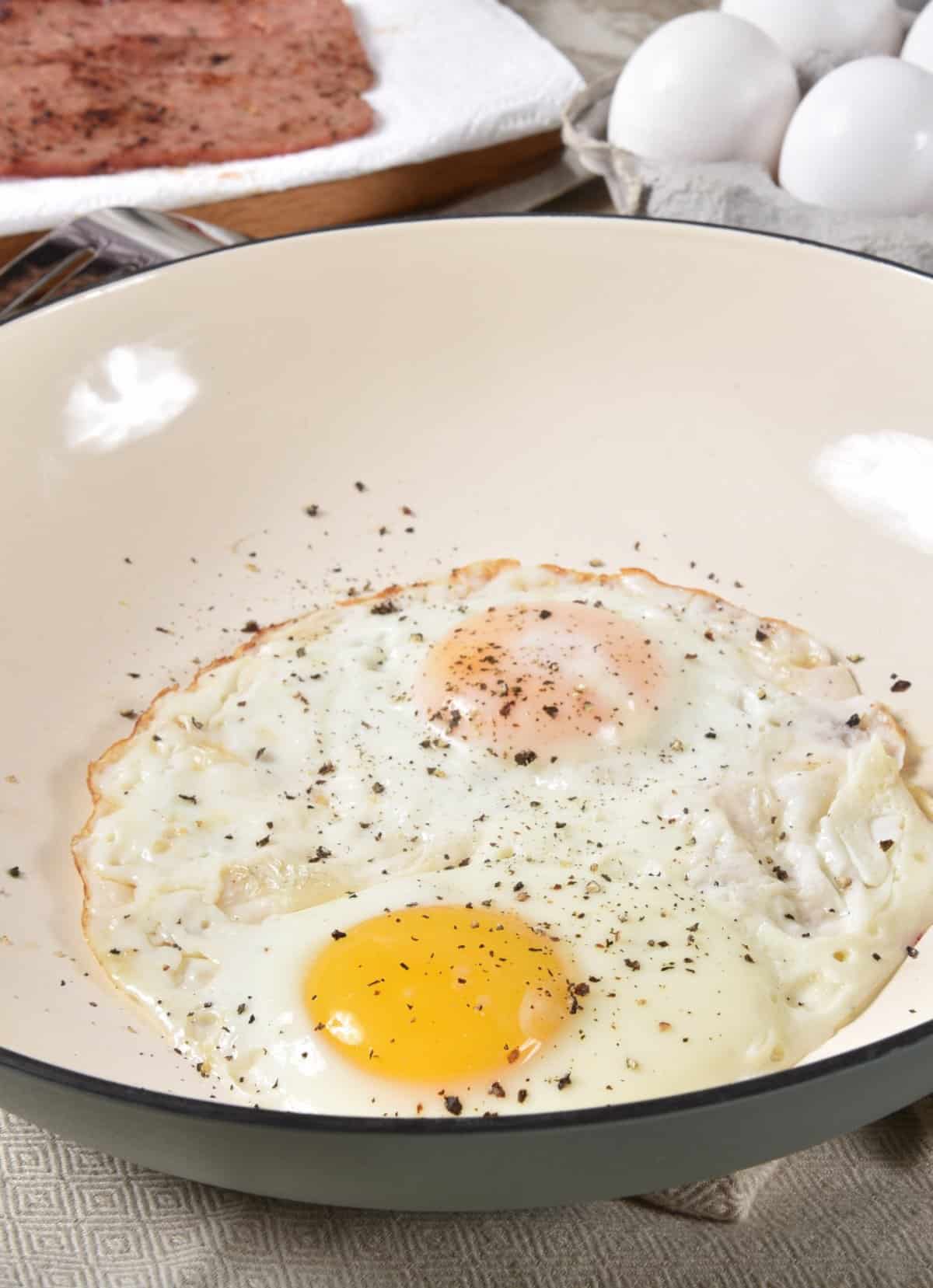 two fried eggs in a pan