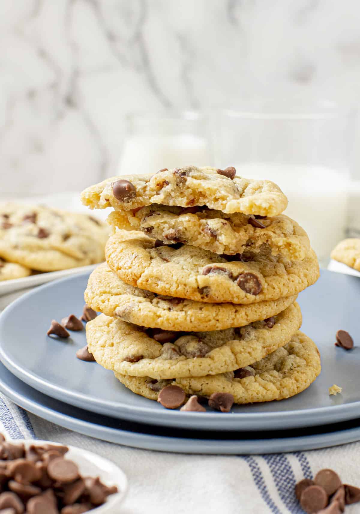 stack of chewy chocolate chip cookies served on a blue round plate