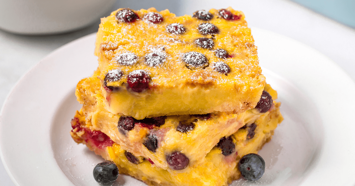 Three lemon blueberry bars on a plate.