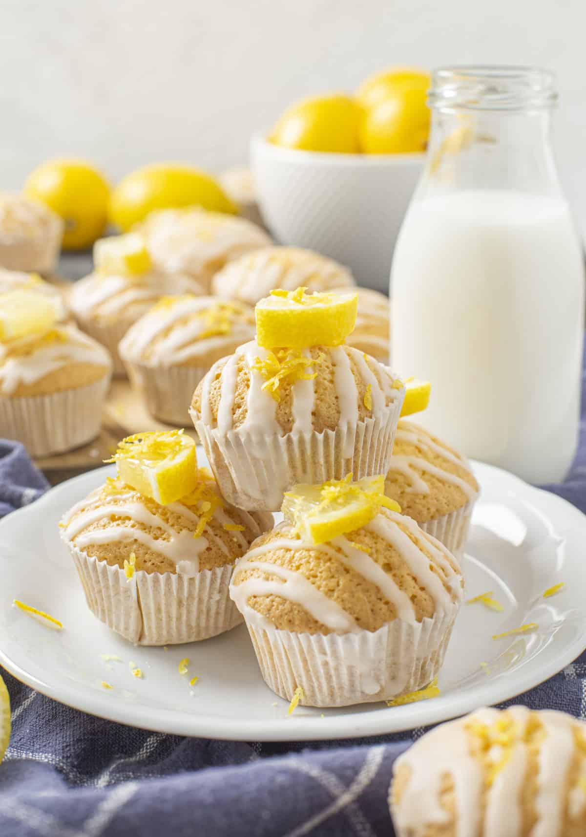 four lemon muffins on a white plate
