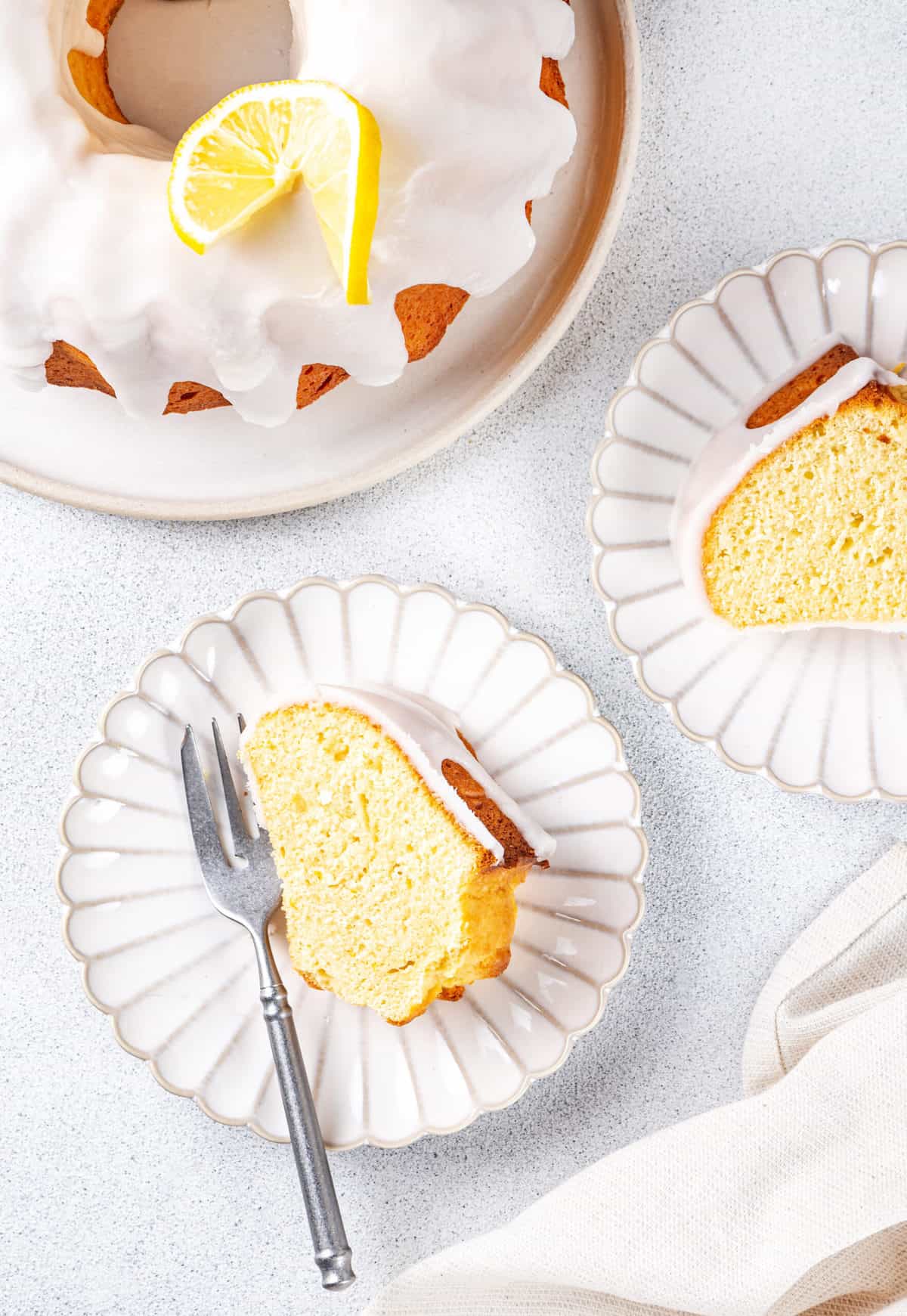 slice of lemon pound cake served on a plate with a silver fork