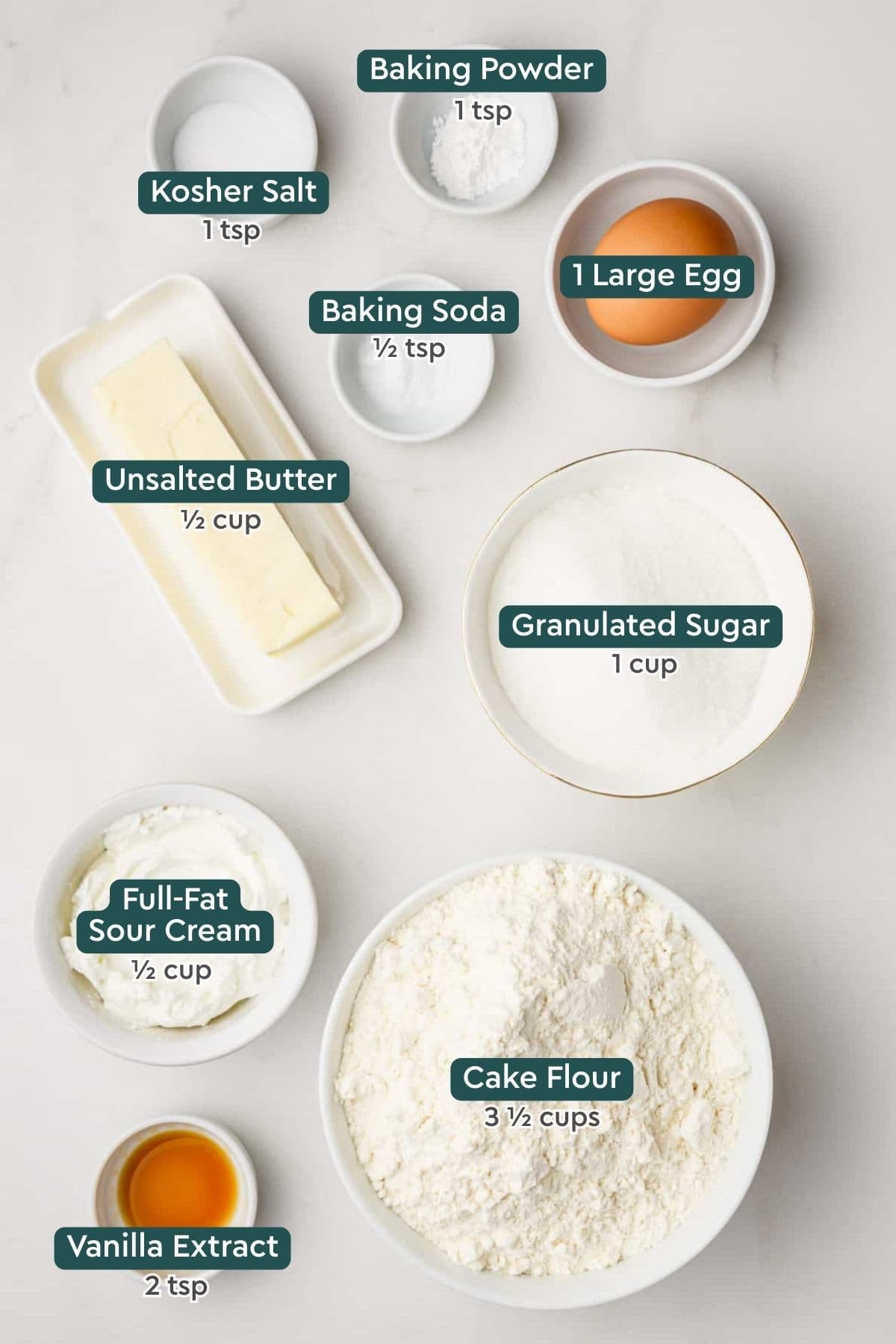 Ingredients for copycat Lofthouse cookies, including baking powder and soda, salt, egg, butter, sugar, sour cream, cake flour, vanilla.