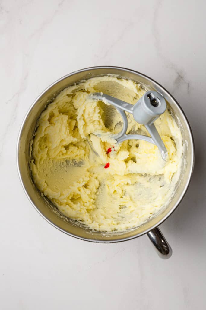 Food coloring added to bowl of frosting.
