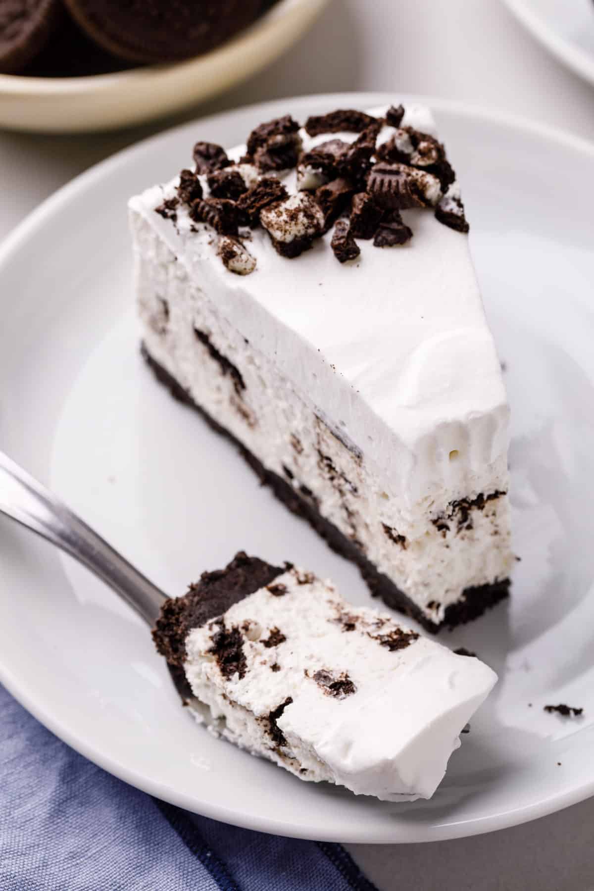 slice of no bake oreo cheesecake on a plate with a fork