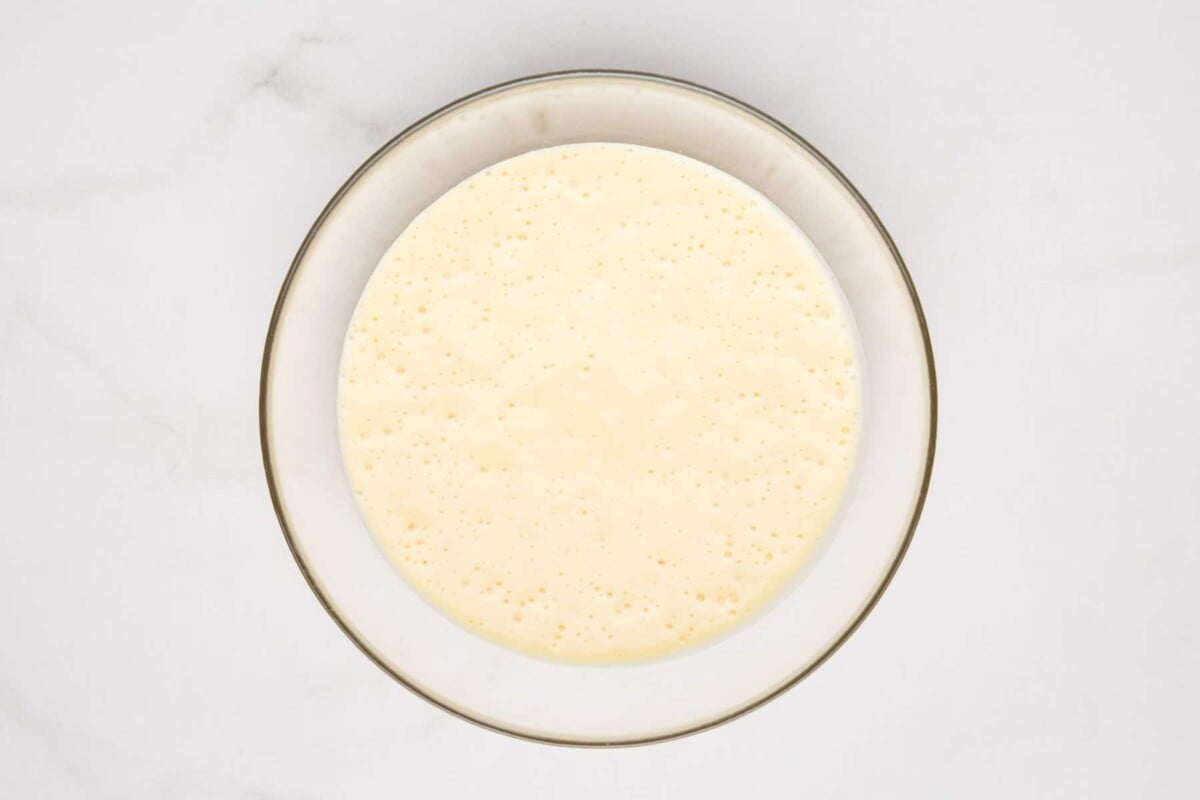 Pancake batter in glass bowl.