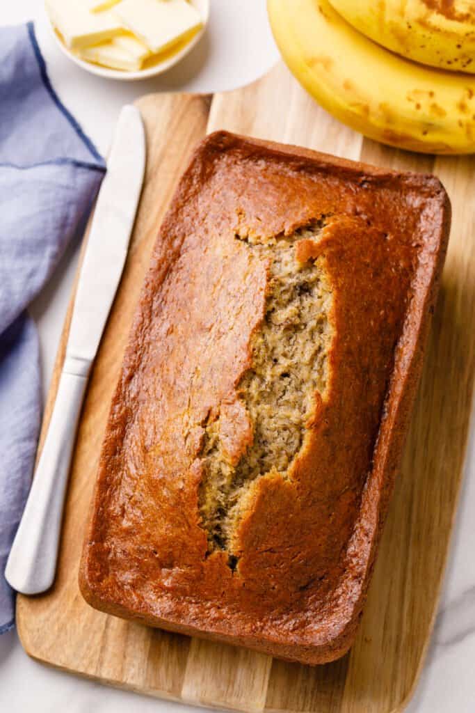 sour cream banana bread on a wooden cutting board