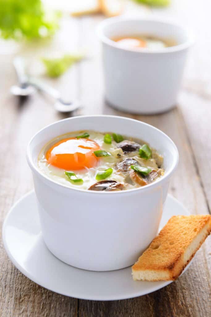 baked eggs in a white cup 