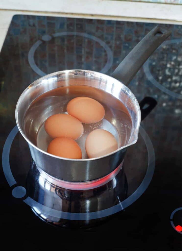 hard boiled eggs in a pot on the stove