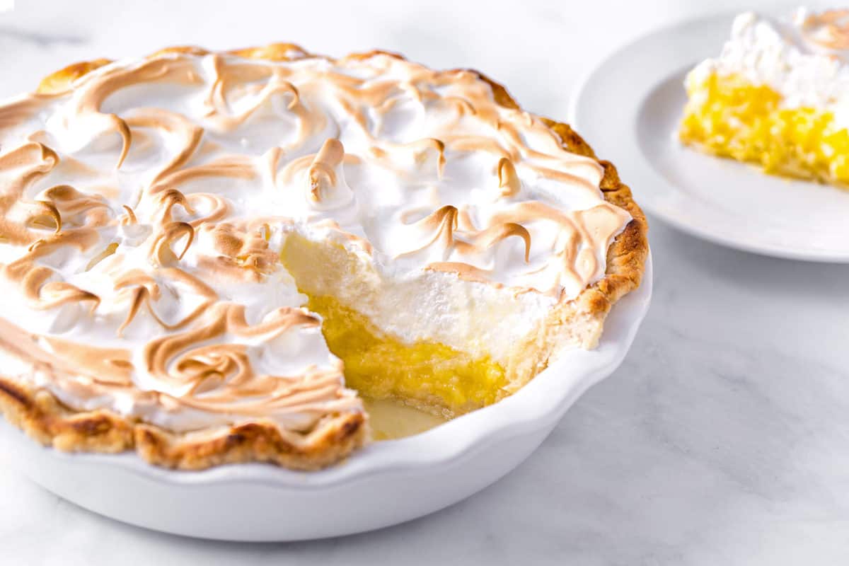 Lemon meringue pie with a piece missing. 