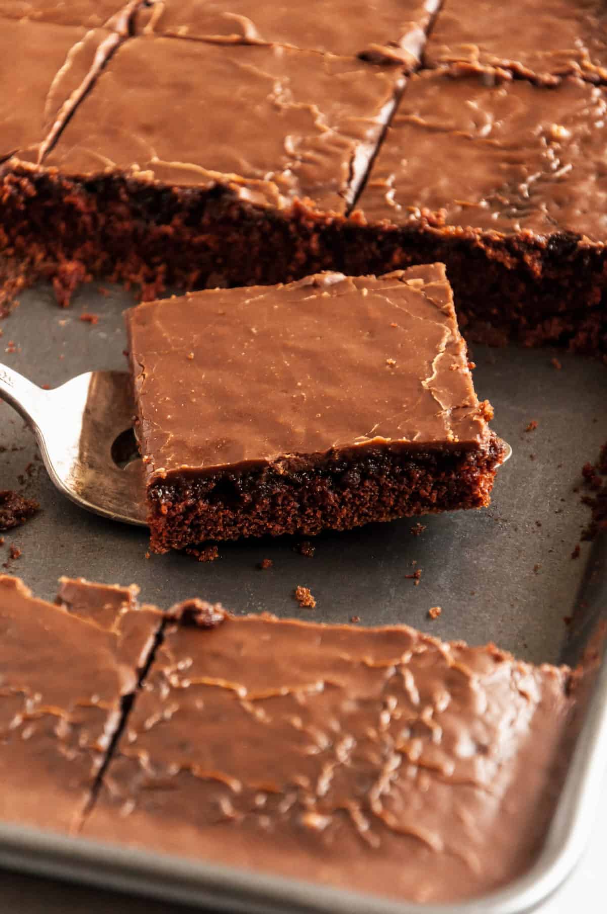 a piece of texas sheet bake being served on a cookie sheet