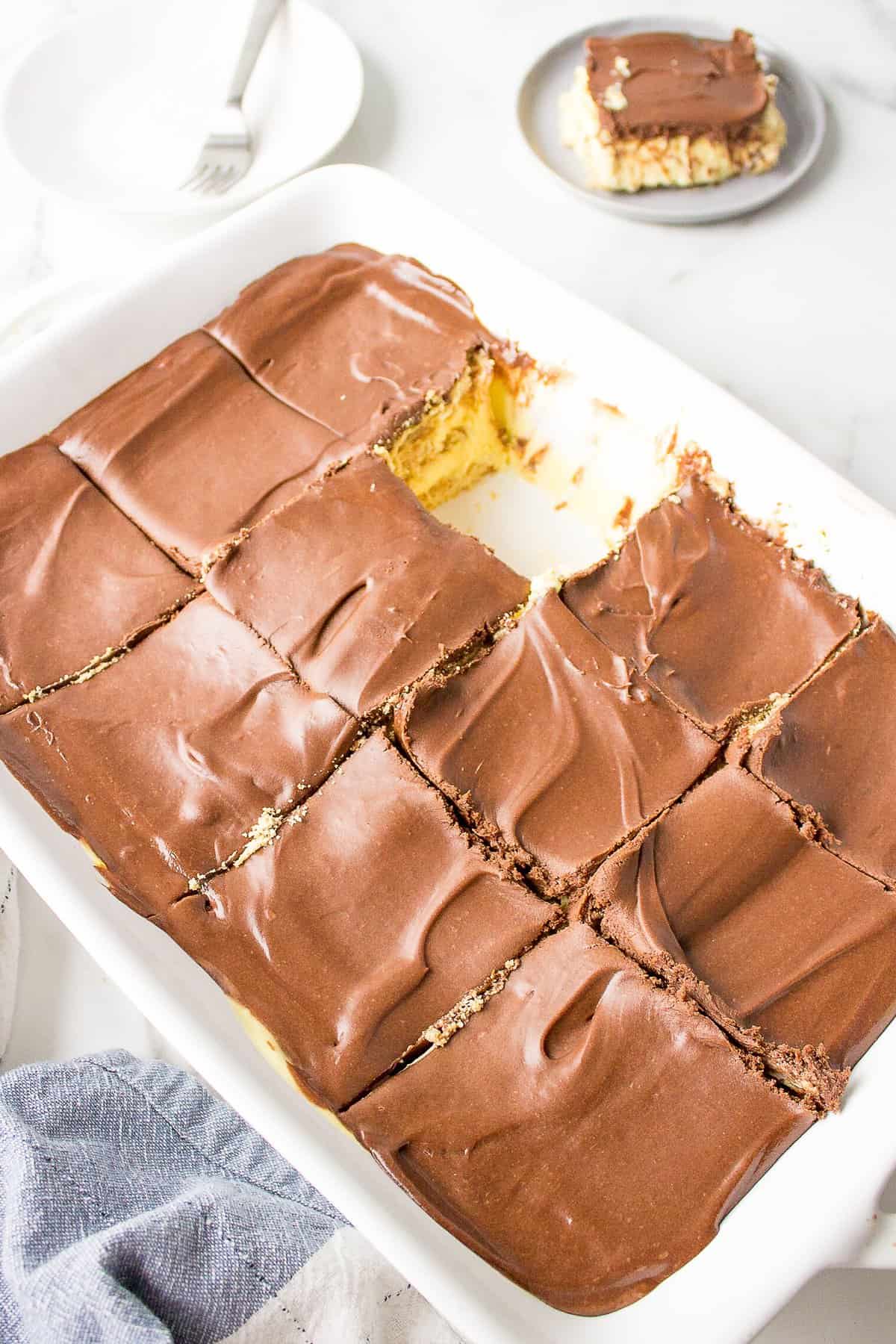 no bake chocolate eclair cake sliced served in a casserole dish