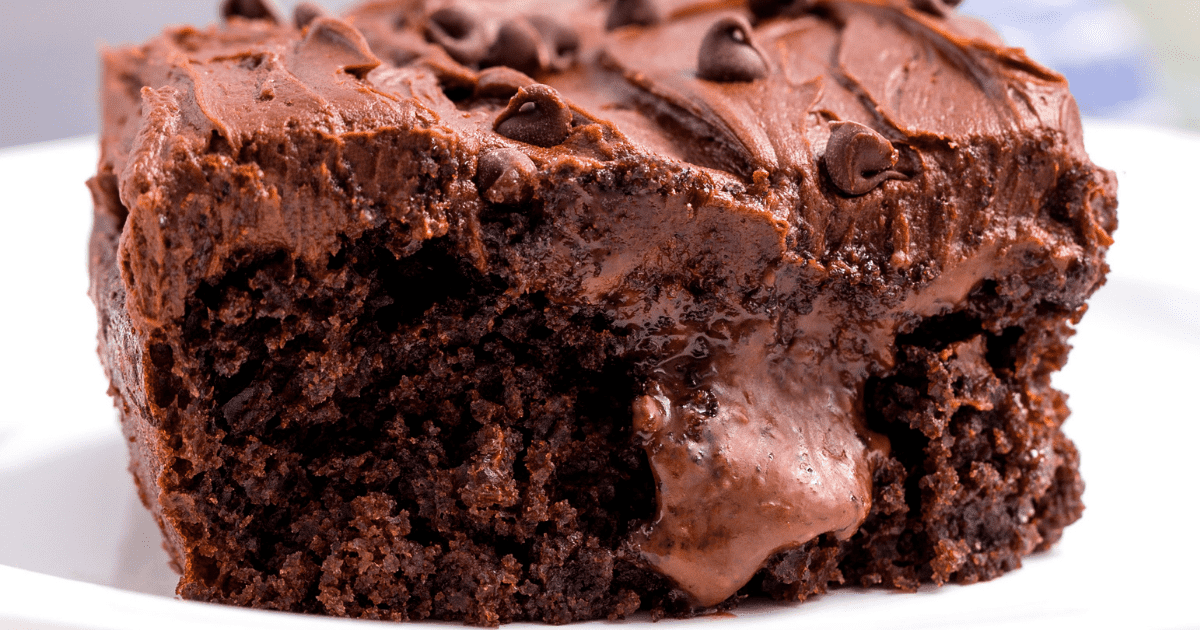 A slice of chocolate poke cake on a plate.