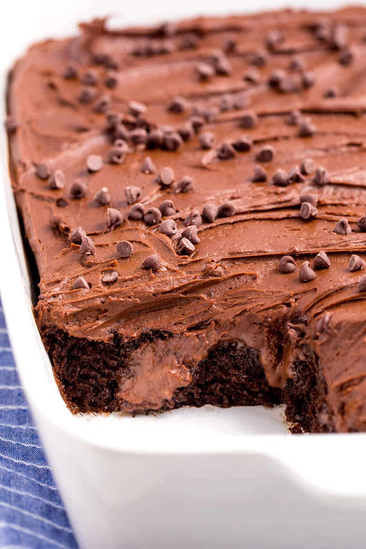 cross section of chocolate poke cake served in a baking dish