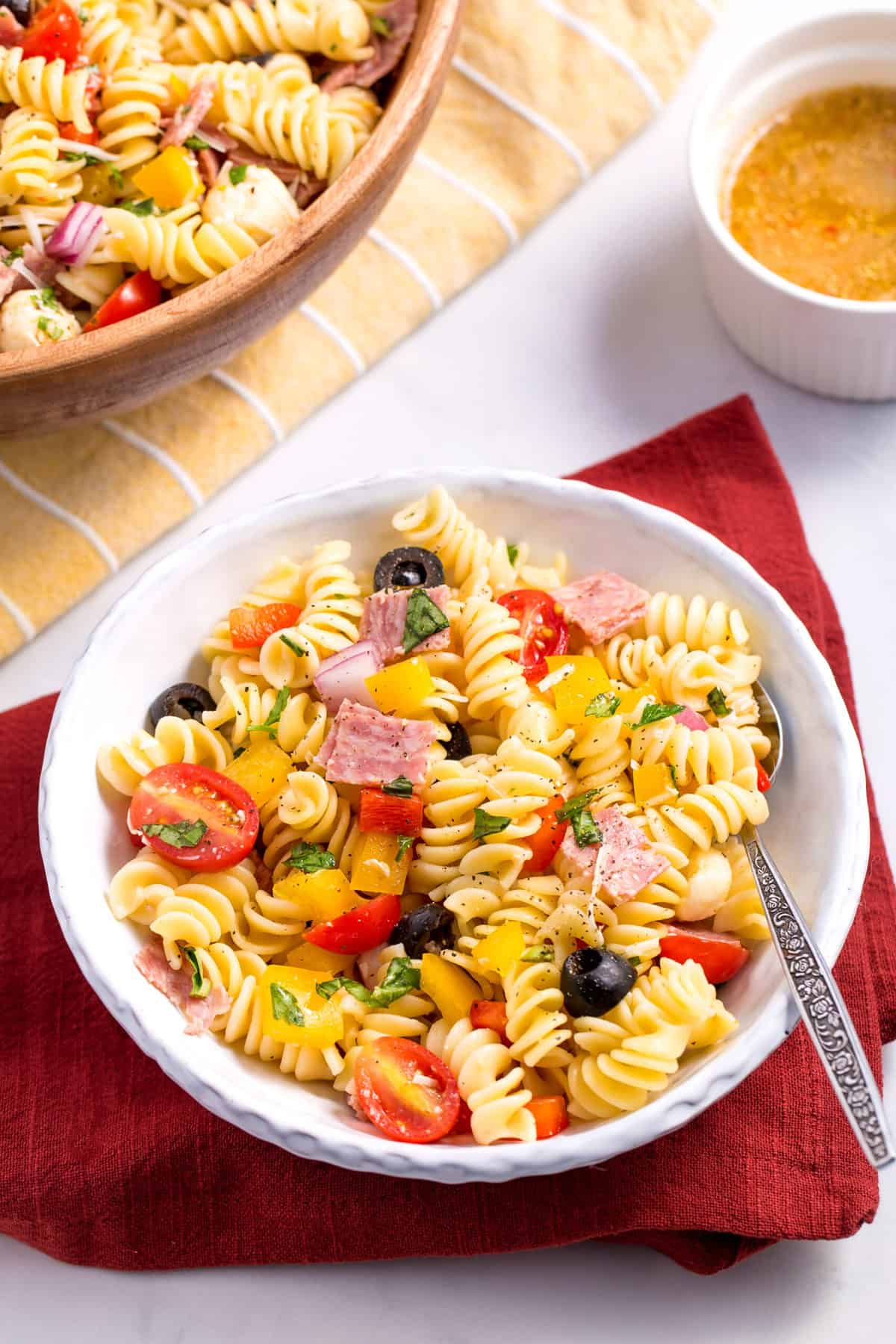 bowl of italian pasta salad with a silver spoon