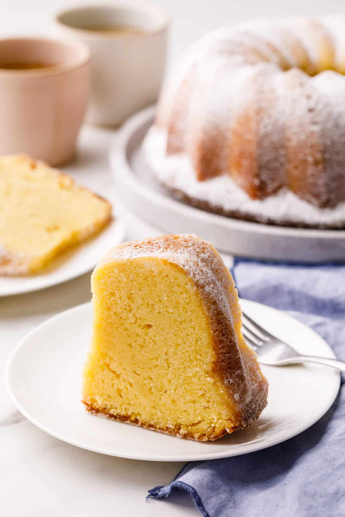 slice of kentucky butter cake served on a white round plate with a silver fork