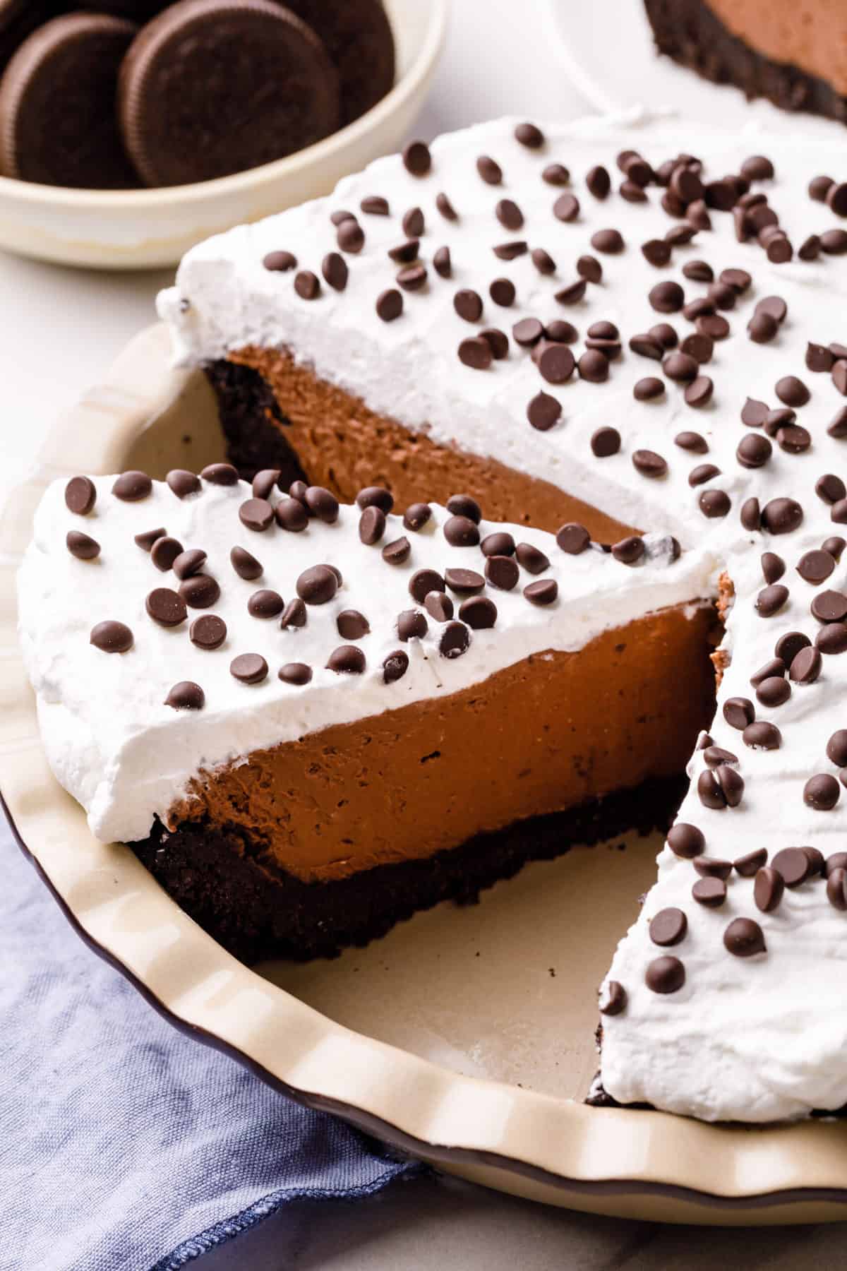 no bake chocolate cheesecake served in a pie dish with a slice cut