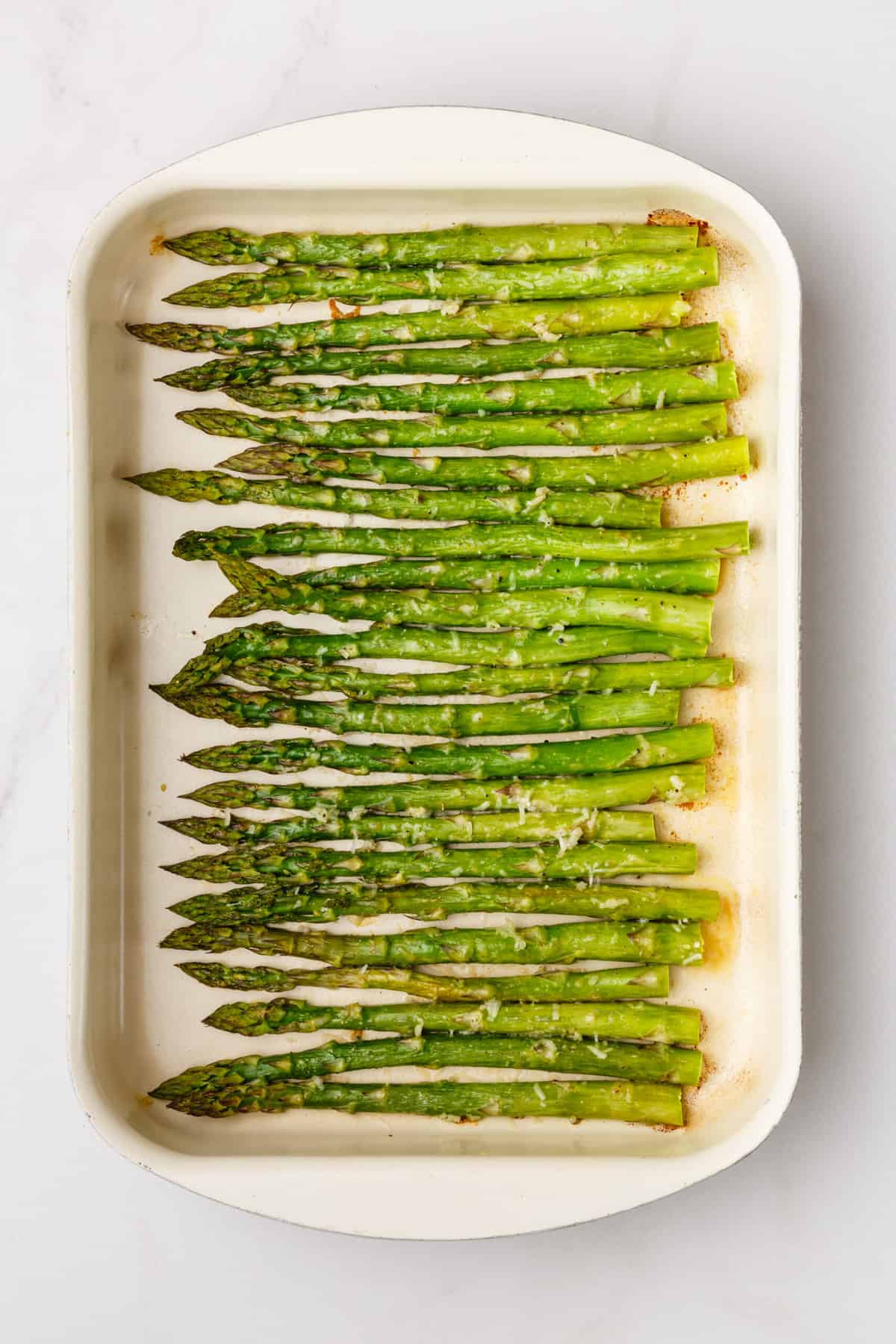 Roasted asparagus on a white plate. 