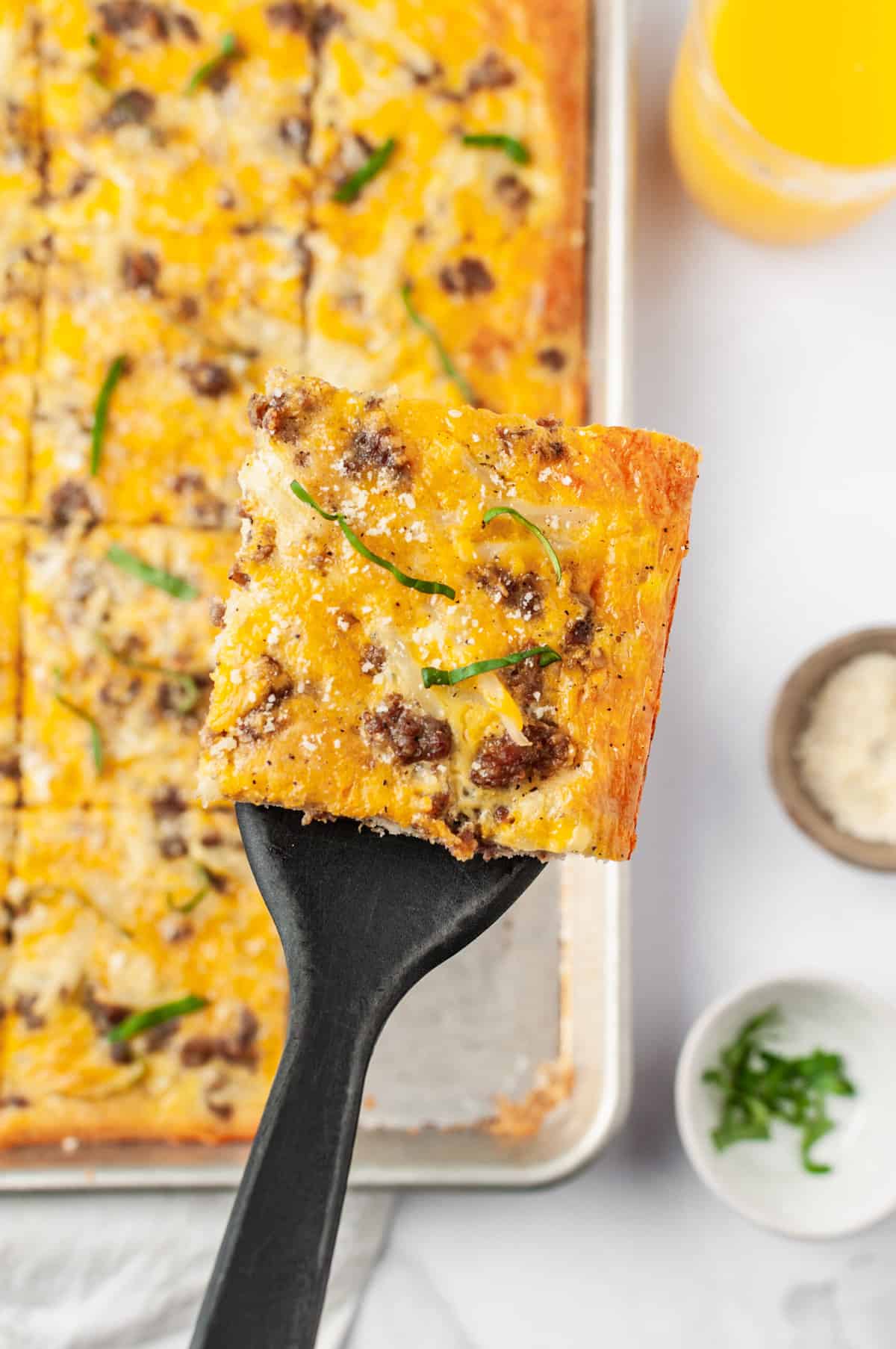 serving of breakfast pizza on a spatula