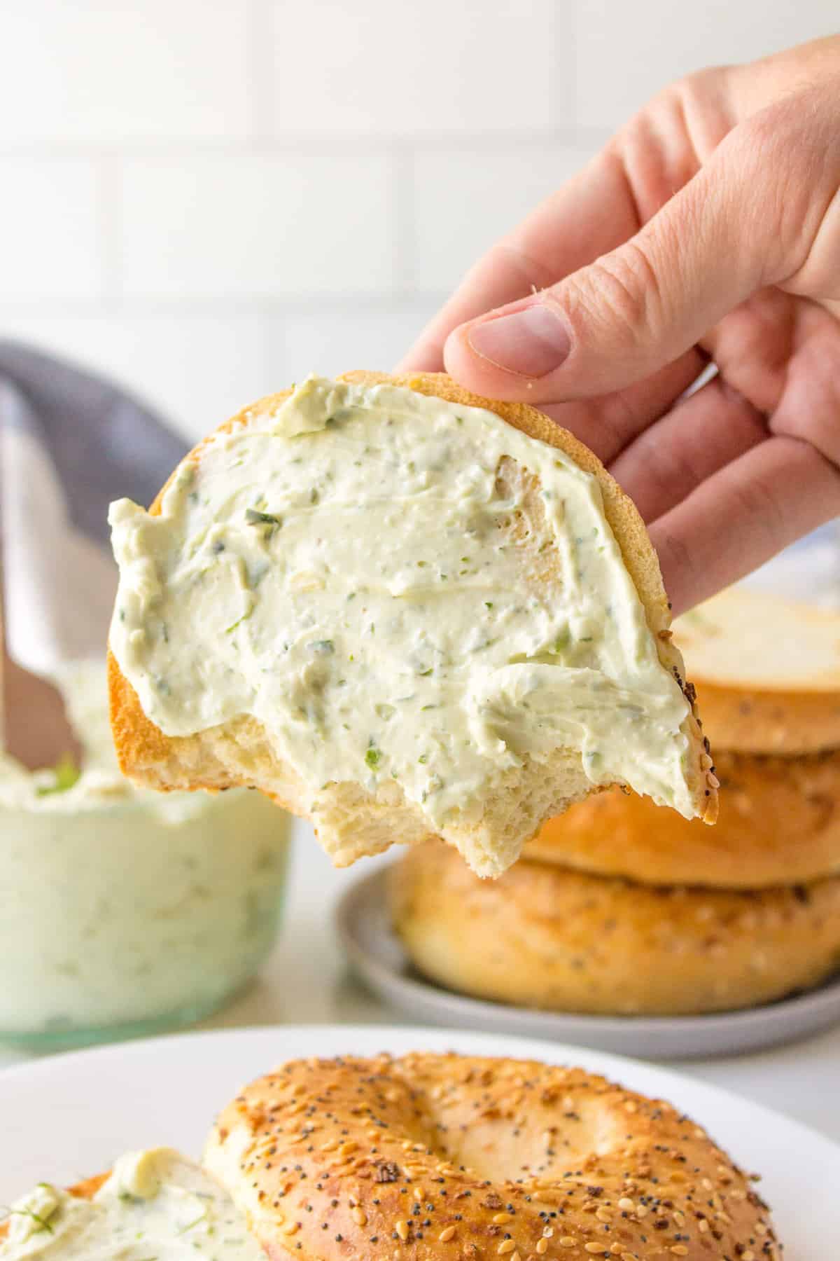 herb cream cheese dip on an everything bagel