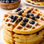 stack of waffles topped with fresh blueberries