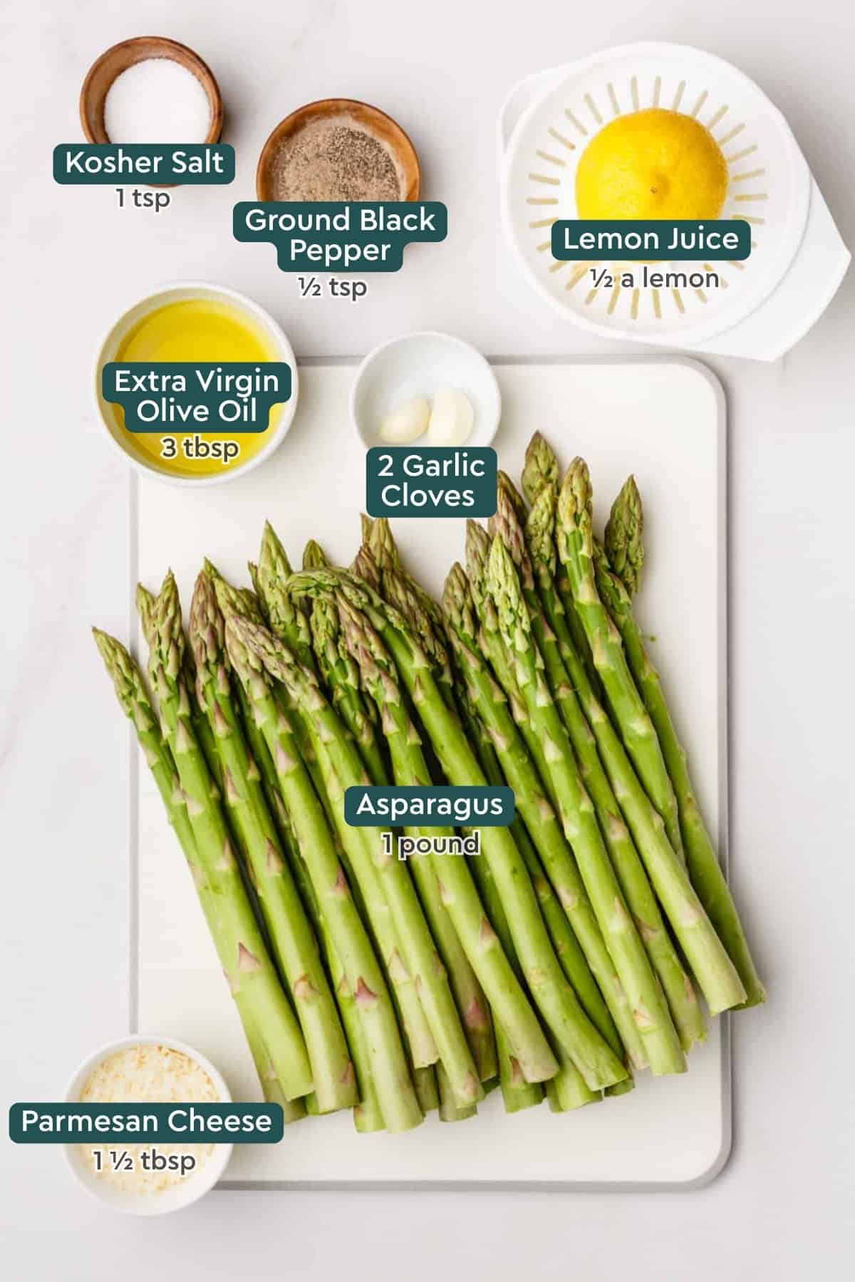 Ingredients for oven roasted asparagus: salt, pepper, lemon, oil, garlic, and asparagus.